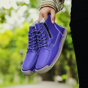 Detailed view of purple hand-stitched Martens boots with a side zipper and rubber sole.
