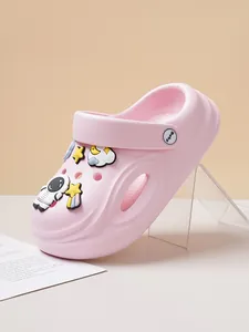 Detailed view of pink children's clogs with cute cartoon charms and Baby strap button