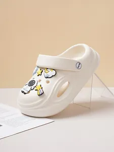 Close-up detail of white clog shoe with cute astronaut and star charms