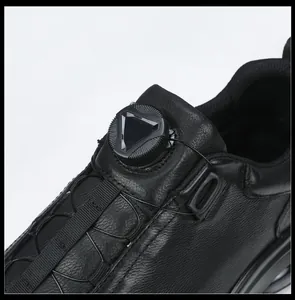 Detailed close-up showing the rotating knob closure on black genuine leather shoes