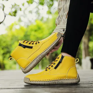 Detail of yellow hand-stitched Marten boots with side zipper and durable soft sole.