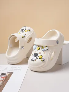 Detailed macro view of white leisure clogs featuring astronaut and space charms decorations