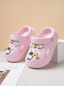 Close-up detail of pink clogs featuring cute astronaut and star charms on a soft background