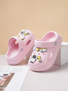 Close-up of pink children's clogs with cute astronaut and space charms