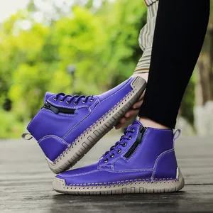 Detail of purple hand-stitched Martin boots with side zipper and textured sole