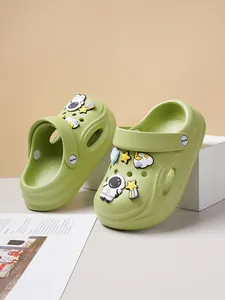Detail view of light green kids' clogs with cute astronaut and star charms