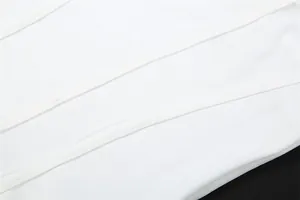 Close-up detail of white fabric and high-quality stitching on a slim-fit dress garment
