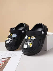 Close-up of black kids' casual clogs decorated with cute astronaut and star charms