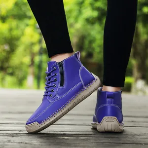 Detail view of purple hand-stitched Martin boots with side zipper and flat sole