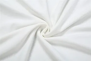 Macro view of soft white fabric texture showing delicate weave and high drape quality