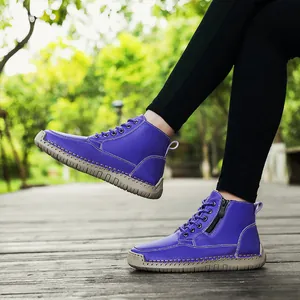 Detailed side view of purple leather boots with hand-stitched sole and side zipper