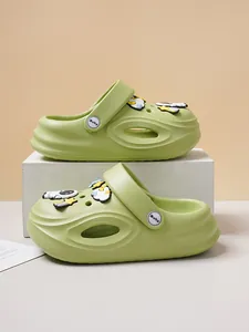 Side view of green kid's clogs with cute cartoon astronaut and space themed charms