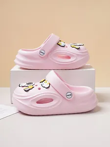 Close-up detailed view of pink kids' clogs featuring cute astronaut and star charms