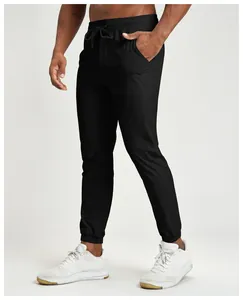Detail view of men's quick-dry black joggers featuring elastic waistband and drawstring.