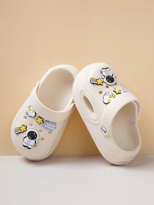 Detailed shot of white comfortable clogs featuring cute astronaut and star charms.