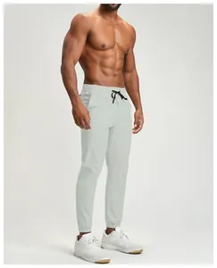 Detail of light gray quick-dry breathable men's cuffed fitness joggers