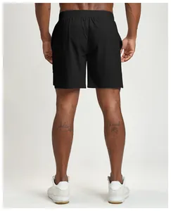 Rear view of black quick-dry men's sports shorts on model for fitness and running