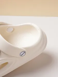 Detailed macro view of comfortable white baby clogs focusing on heel and strap button