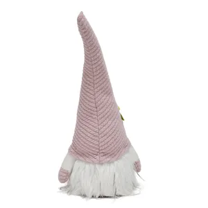Back view of a plush Easter gnome with a textured pink pointed hat and white beard