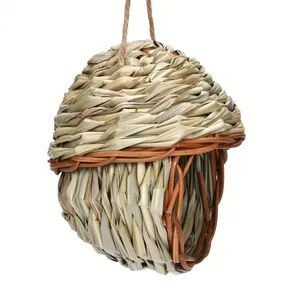 Hand-woven natural straw bird nest detail showing durable texture and hanging rope