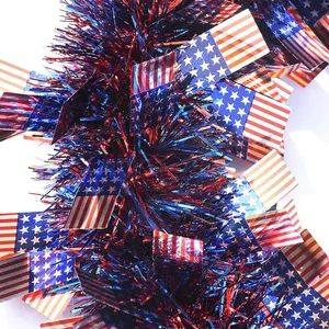Macro detail of Independence Day tinsel garland decorated with miniature American flags.