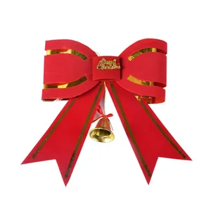 Large red Christmas bow decoration with gold bell and Merry Christmas lettering