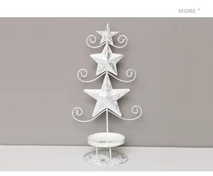 Rustic white iron Christmas tree candle holder with star accents for holiday decor.
