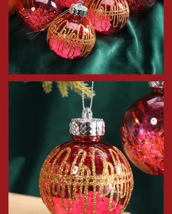 Close-up detail of red Christmas ball with gold glitter grid and pink decorative beads.