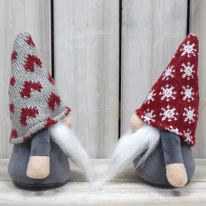 Detail of handmade plush Christmas gnomes with knitted hats and white beards