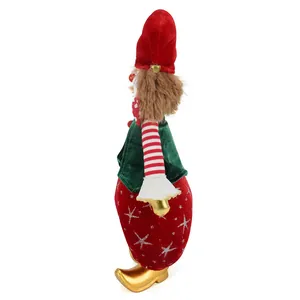 Detailed side view of handmade circus clown doll Christmas ornament with gold shoes