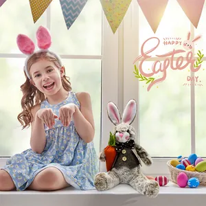 Cuddly plush Easter bunny doll wearing a bow tie in a festive spring window setting.