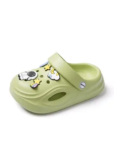 Close-up of green children's clogs featuring cute astronaut and star charms