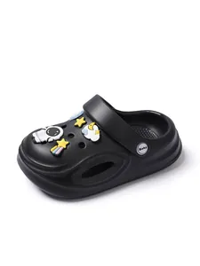 Detail view of black kids' clog shoes featuring cute astronaut and star cartoon charms