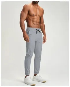 Grey athletic joggers for men featuring quick-dry fabric and a comfortable drawstring waist.