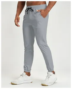 Side view of grey quick-dry men's joggers with elastic cuffs and drawstring waist.