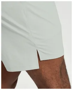 Detailed view showing the breathable fabric and side slit of men's quick-dry sports shorts.