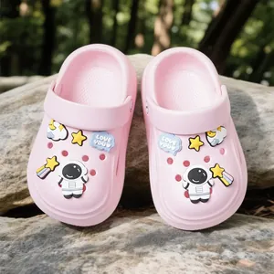 Comfortable pink kids' clogs featuring cute astronaut and star charms on stones