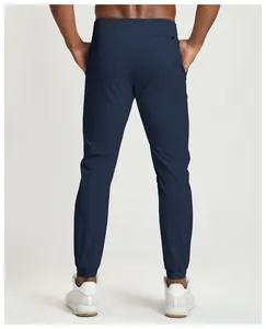 Back view of men's navy blue quick-dry joggers featuring a secure rear zipper pocket