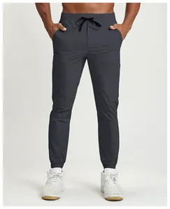 Detail view of quick-dry charcoal grey joggers for men with elastic drawstring waist