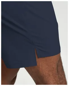Close-up of navy blue men's sports shorts showing the functional side slit detail.