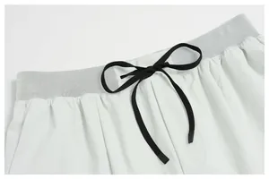 Detailed close-up of mesh waistband and black drawstring on men's quick-dry sports shorts.