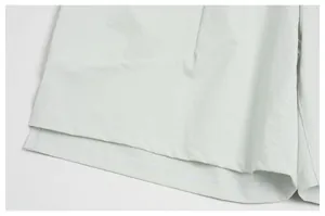 Detailed close-up showing the hem and quality stitching on light green quick-dry sports shorts
