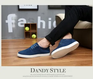 Close-up detail of blue cow suede men's casual shoes featuring white rubber outsoles
