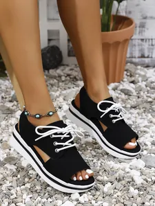 Stylish black lace-up platform sandals with open-toe design for beach and summer wear.