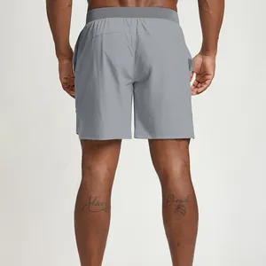 Back view of grey quick-dry men's athletic shorts for gym, running, and tennis sports