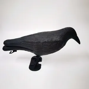 Detailed view of realistic black crow decoy with feather texture and base for garden.