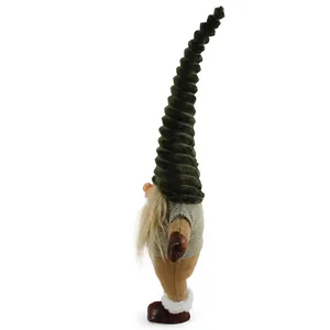 Side view detail of a Christmas gnome figurine standing on one leg with a tall hat