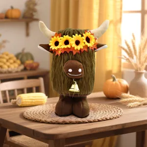Close-up of Highland Cow plush with sunflower crown and autumn harvest themed decor props