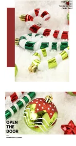 Close-up of festive Christmas ornaments including candy canes and baubles on snow