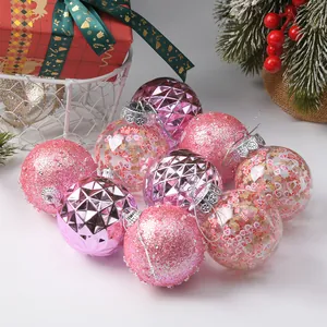 Close-up detail of various pink Christmas ornaments with festive glitter designs